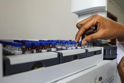 close up of hand on test vials 