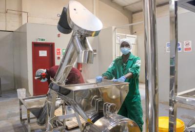 Photo of man milling grain 