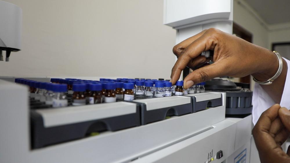 Hand grabbing samples in a lab