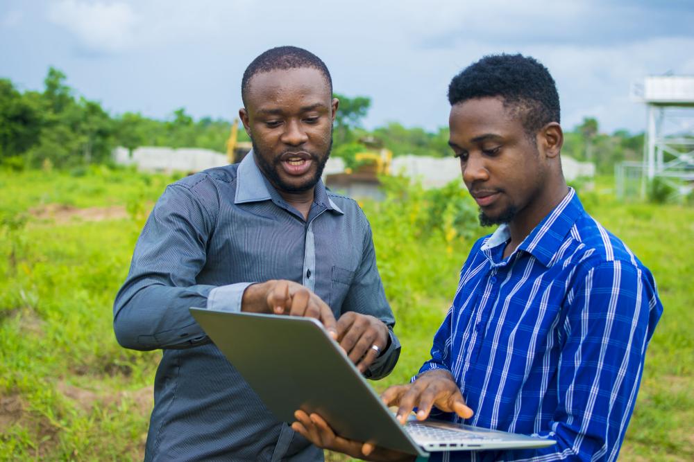 Stock image of young African men consulting 