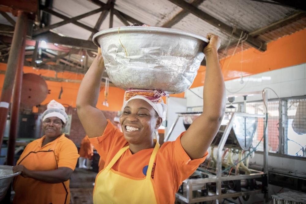 Women holding silver bucket above head